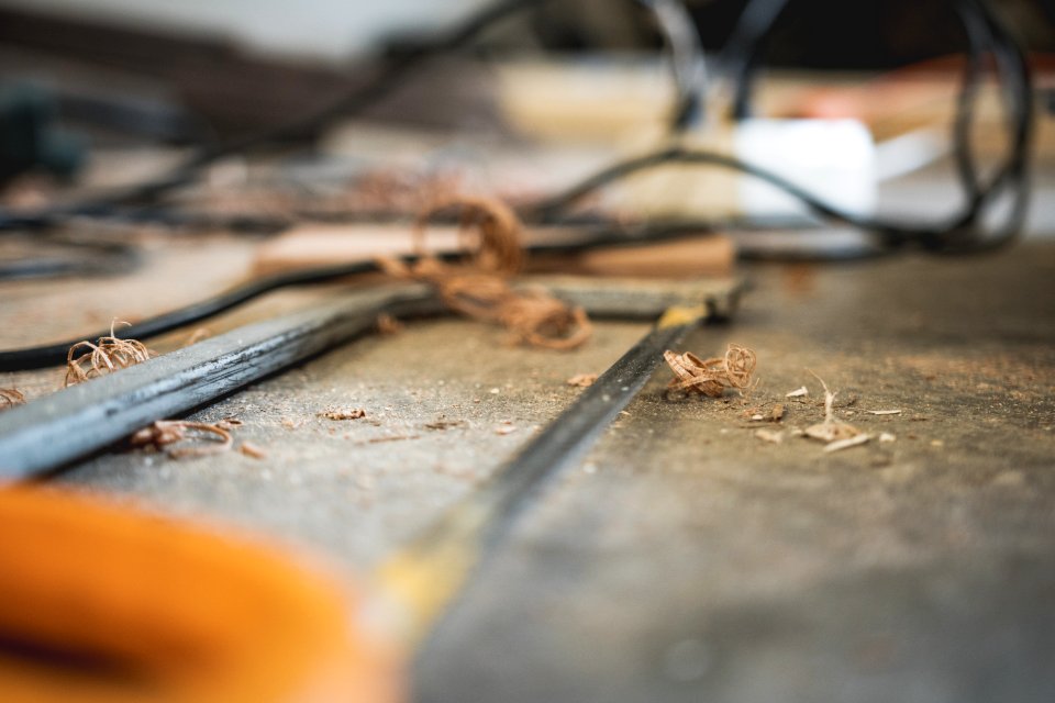 Wood Chips On Top Of Gray Hacksaw