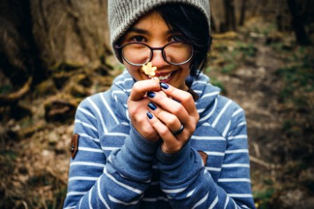 Woman In Blue And White Striped Pullover Hoodie Holding Flower photo