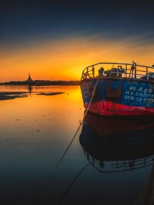 Blue And Red Ship During Golden Hour photo