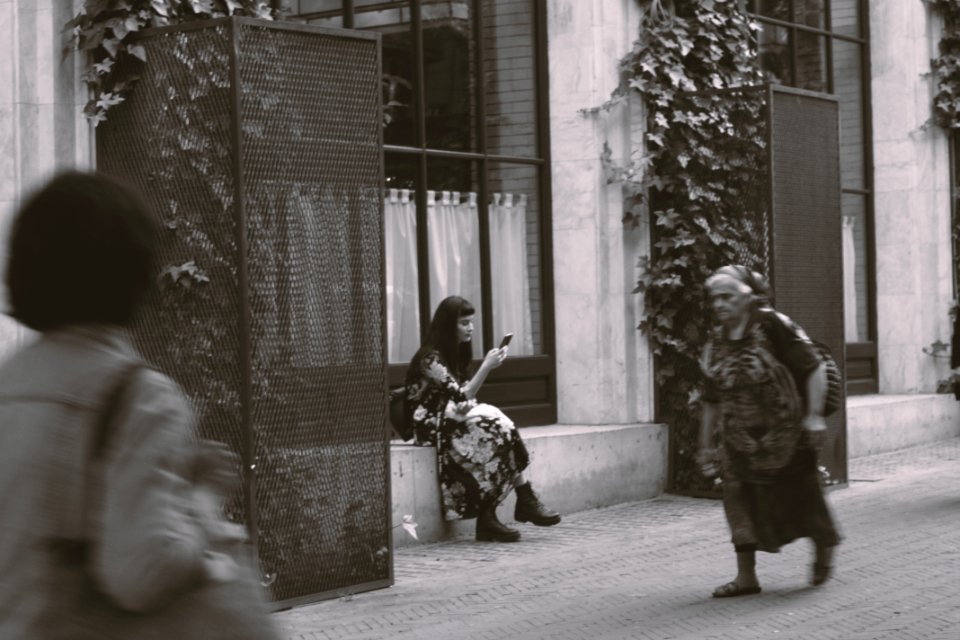 Woman Sitting On Gray Concrete Front Step Of House