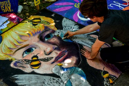 Man Painting Face Of Human And Bird photo