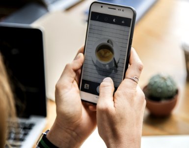 Person Holding White Android Smartphone With Black Rear Case photo