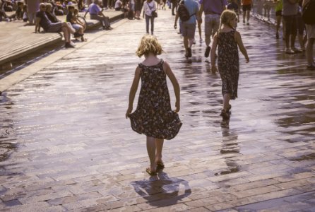 Grayscale Photo Of Two Woman Walks On Bricks Pavement Front Of People At Daytime photo