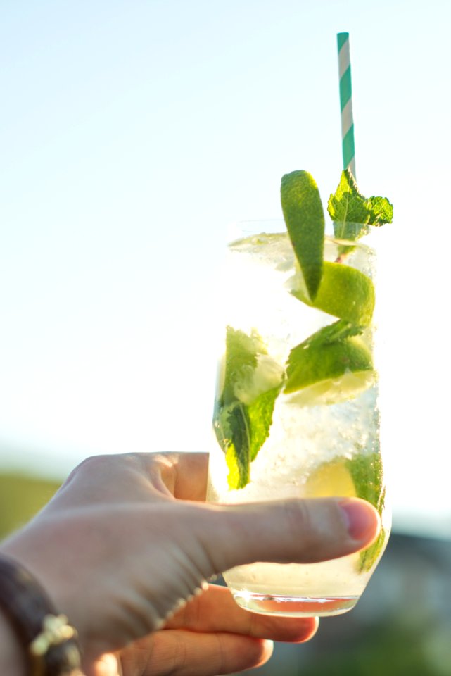 Person Holding Glass Filled With Lemonade