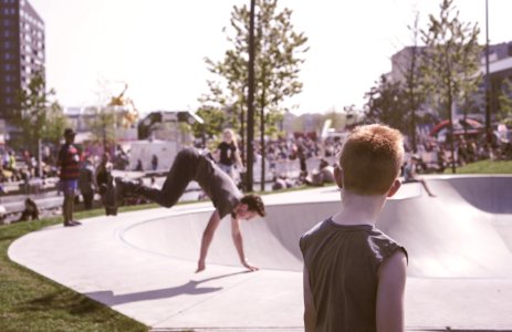 Man In Black Tank Top Looking At Man In Black T-shirt Doing Hand Stand Routine photo