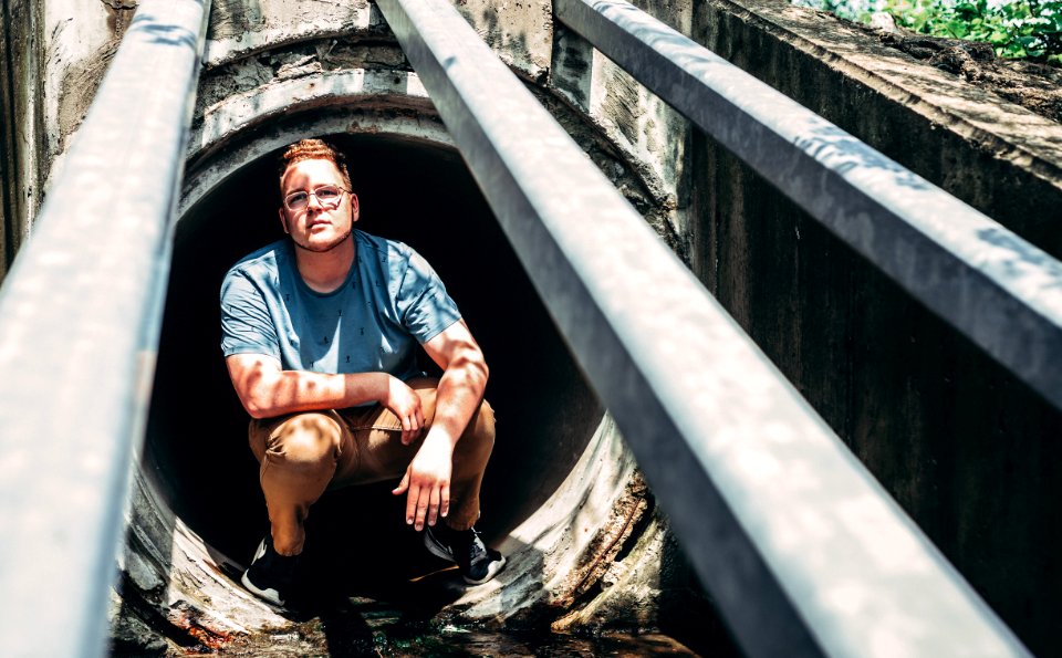 Man Sitting On Manhole