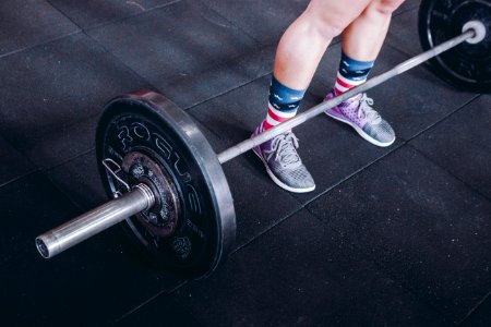 Person Standing Near Black Barbell photo