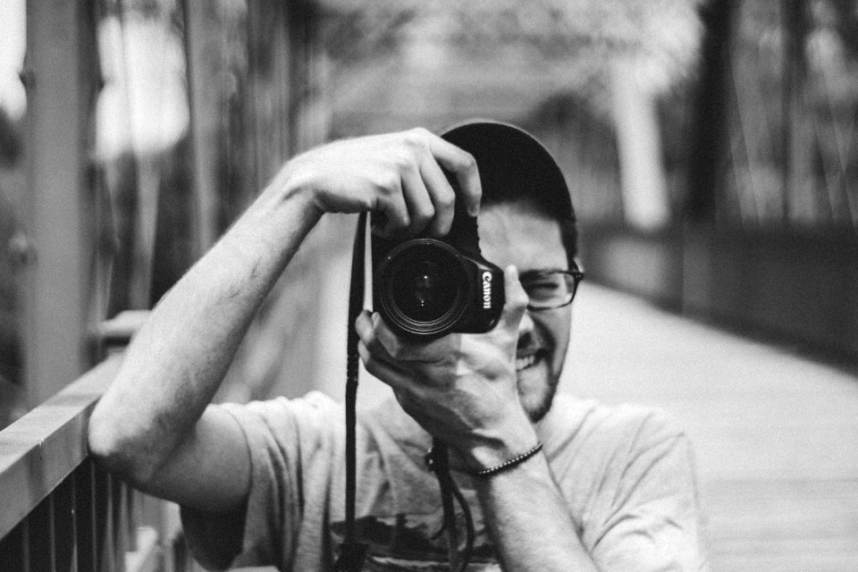Man Holding Canon Dslr Camera Taking Picture