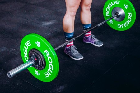 Person Standing In Front Of Green And Gray Barbell photo