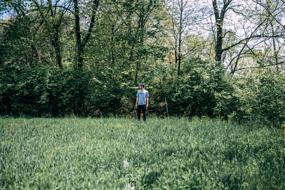 Photography Of A Man Standing On Grass Field