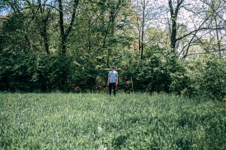 Photography Of A Man Standing On Grass Field