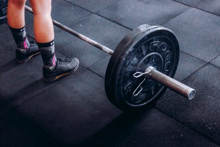 Person Standing Near Black Barbell photo