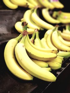 Selective Focus Photo Of Bunch Of Bananas On Black Surface photo