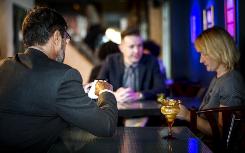 Man Wearing Gray Blazer Sitting On Chair Near Woman Wearing Gray T-shirt photo