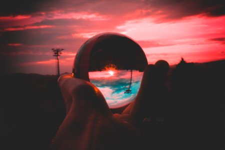 Person Holding Round Clear Glass Decor
