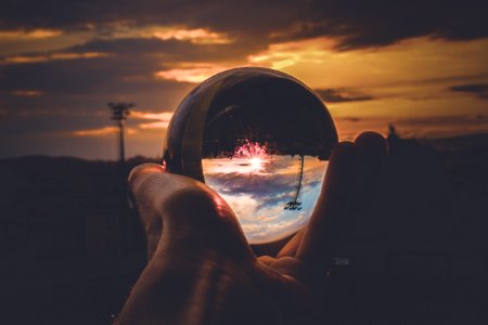 Person Holding Clear Glass Ball photo