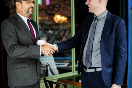 Two Men Wearing Suit Jackets Doing Hand Shake photo