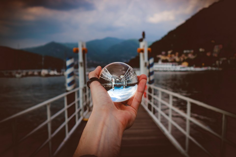 Person Holding Clear Glass Ball