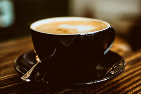 Black Ceramic Cup Filled With Latte photo