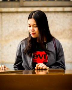 Woman Wearing Black Levis Crew-neck Shirt And Gray Zip-up Jacket photo