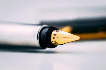Selective Focus Photography Of Fountain Pen On White Surface photo