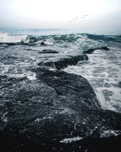 Landscape Photography Of Body Of Water Smashing In The Rocks