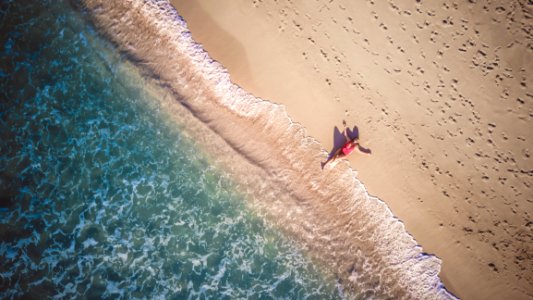 Photo Of Person Lying Beside Seashore