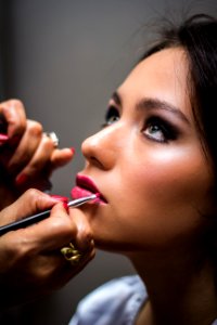 Woman Putting Lipstick On Her Lips photo