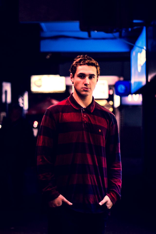 Man Wearing Red And Maroon Striped Long-sleeved Polo Shirt Holding Pockets photo