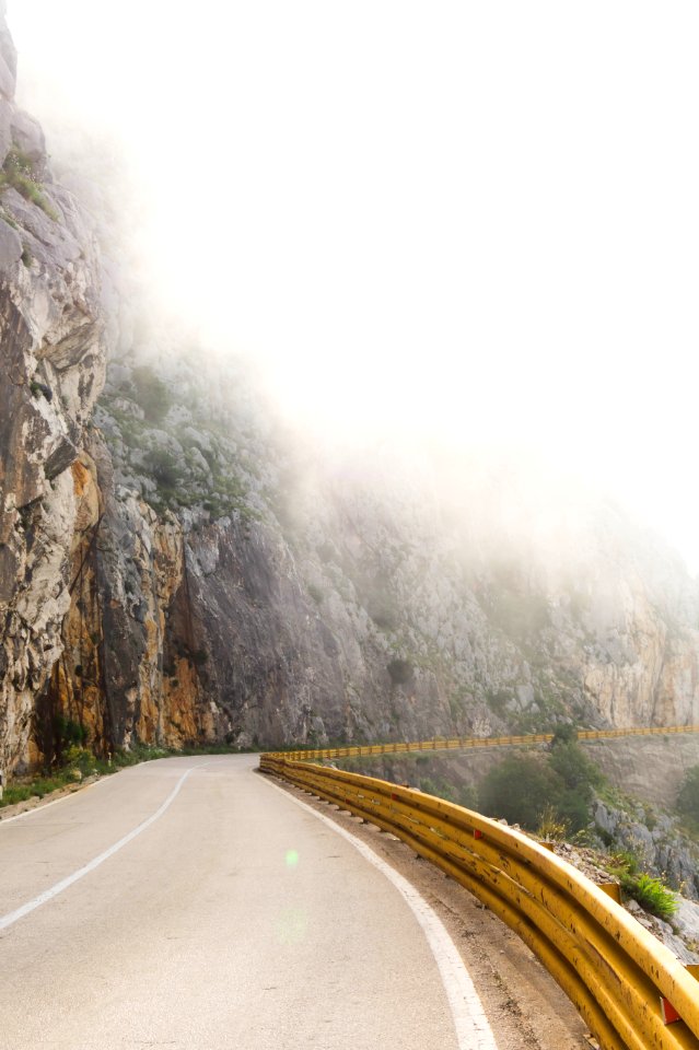 Photography Of Road Near Foggy Mountain