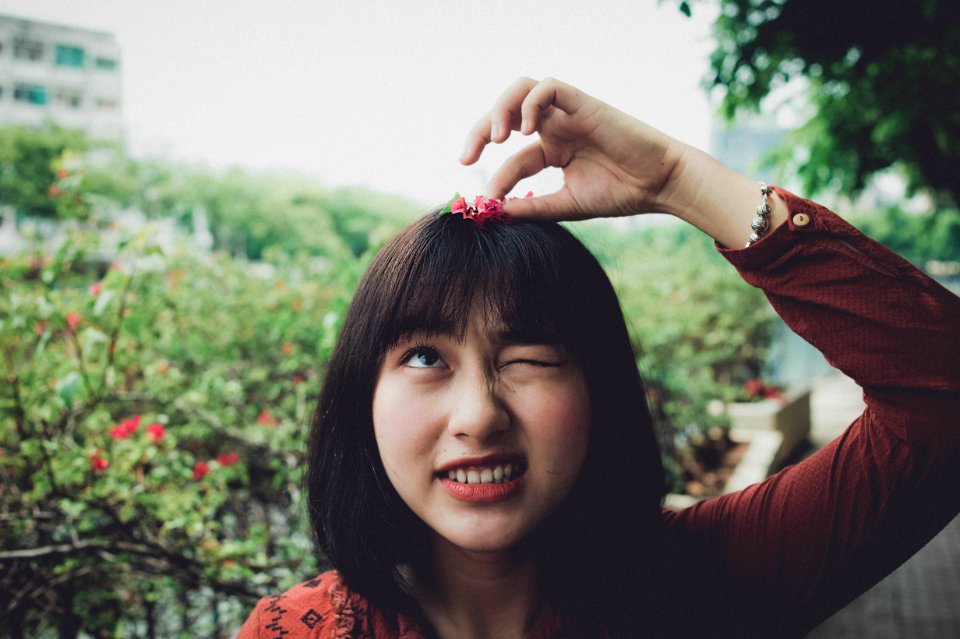Woman Wearing Red Long-sleeved Shirt With Red Petaled Flower On Head