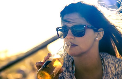 Woman Drinking Beverage On Bottle photo