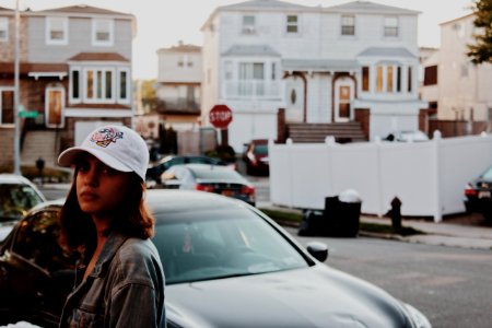 Shallow Focus Photography Of Woman In Gray Denim Jacket Standing Near Car photo