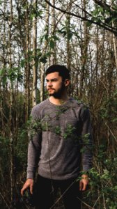 Landscape Photo Of Man Standing On Forest And Wearing Crew-neck Sweatshirt photo