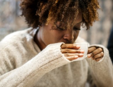 Woman Holding A Cup While Drinking photo