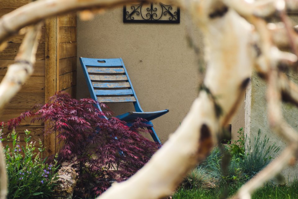 Blue Wooden Chair Near Brown Wooden Wall