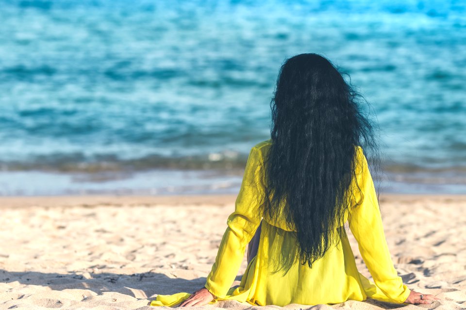 Woman Sitting Near Ocean