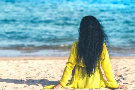 Woman Sitting Near Ocean photo