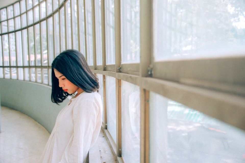 Woman Wearing White Top Beside Window At Daytime
