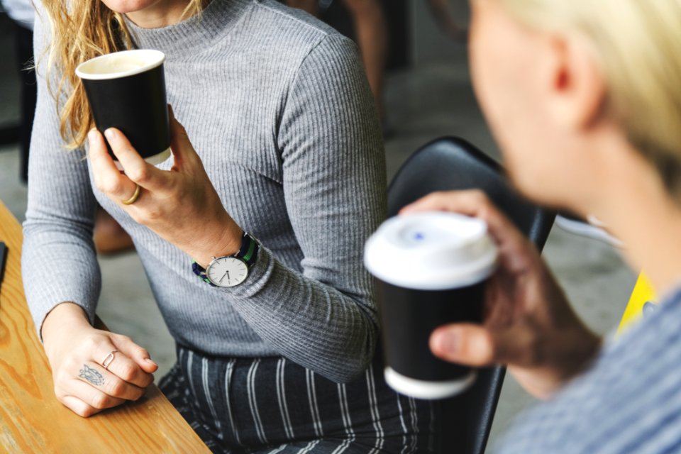 Woman Wearing Gray Sweater Holding Brown Disposable Cup