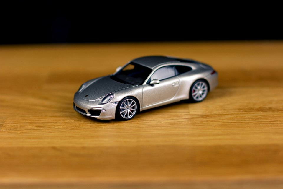 Shallow Focus Of Silver Die-cast Model On Brown Wooden Board