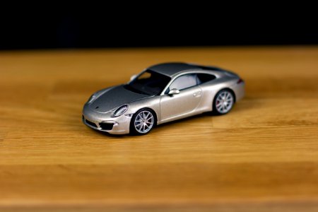 Shallow Focus Of Silver Die-cast Model On Brown Wooden Board