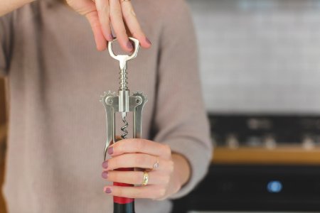 Person Holding Grey And Red Hand Tool photo