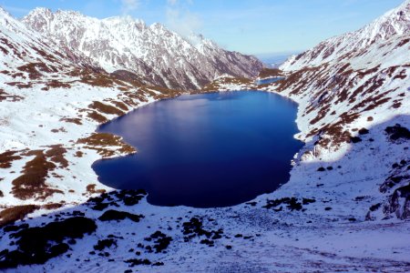 High-angle View Of Body Of Water In Between Snow-covered Mountain Range photo