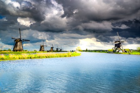 Wind Mills Near Body Of Water