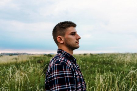 Man Standing On Grass Field photo