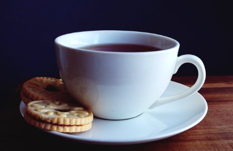 Close-up Photography Of Cup Of Coffee Near Biscuits