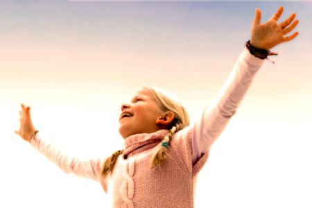 Blonde Haired Girl Wearing Pink Sweater photo