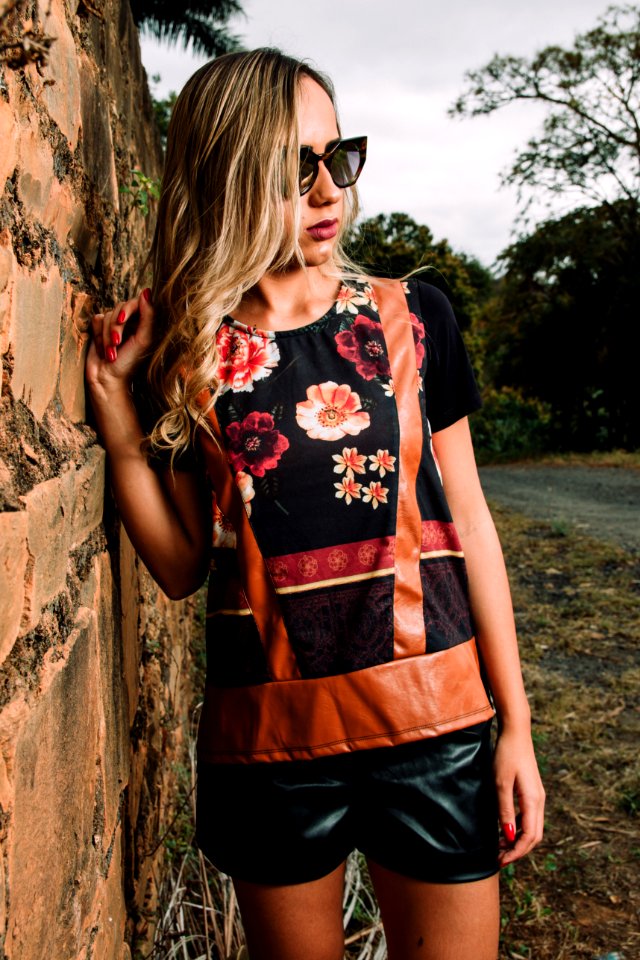 Woman Wearing Black Floral Short-sleeved Shirt And Black Pants Standing Near Wall