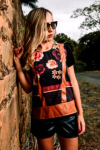 Woman Wearing Black Floral Short-sleeved Shirt And Black Pants Standing Near Wall photo